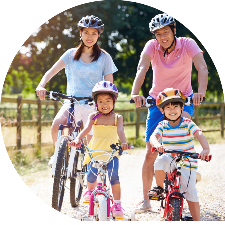 Family of four riding bikes in the country.